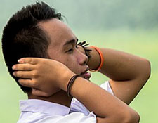 man covering his ears